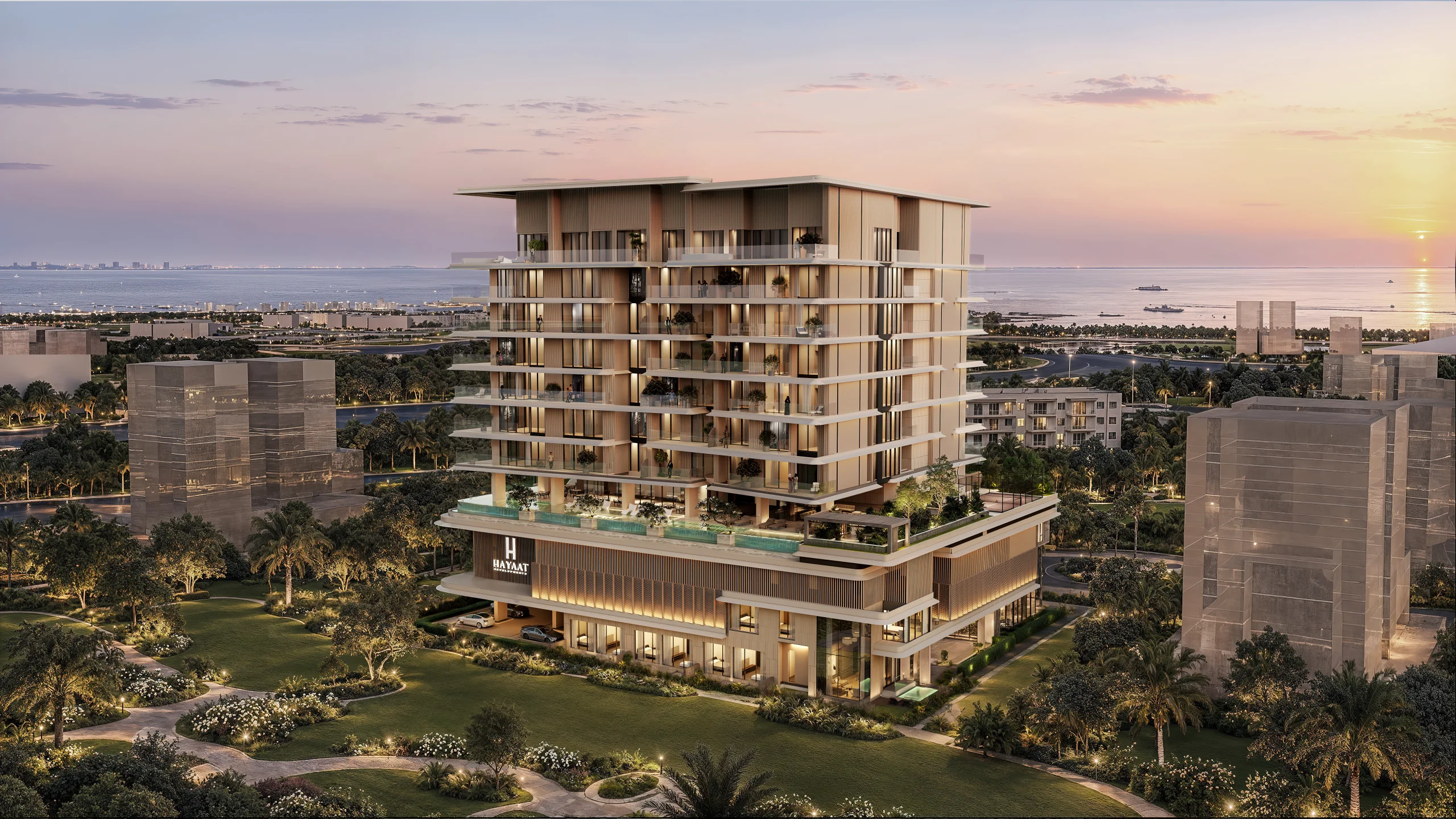 Isolana by Hayaat Developments on Dubai Islands at sunset: a tiered tower with planted balconies rising above landscaped gardens, with the sea beyond